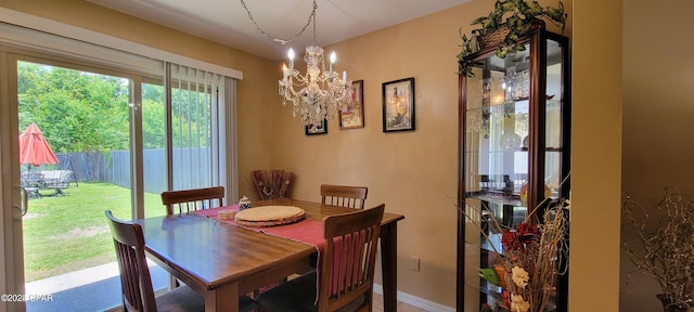 dining area with a notable chandelier and baseboards