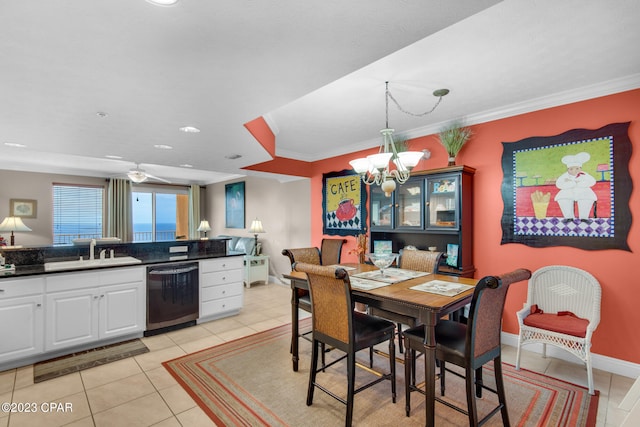 dining space featuring crown molding, sink, light tile patterned floors, and a notable chandelier