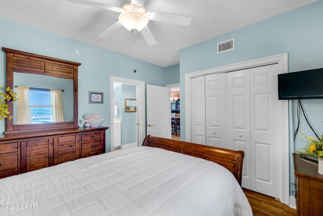 bedroom featuring ceiling fan, a closet, and dark hardwood / wood-style flooring