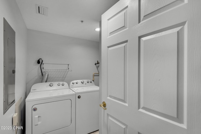 washroom featuring electric panel and independent washer and dryer