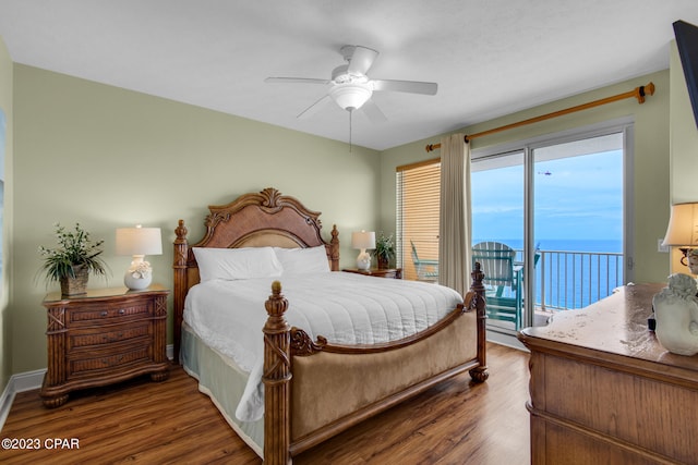 bedroom with multiple windows, dark hardwood / wood-style flooring, access to outside, and ceiling fan