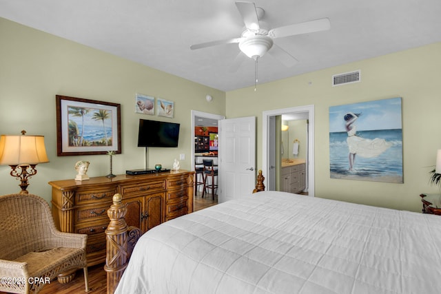 bedroom featuring ceiling fan, connected bathroom, and wood-type flooring