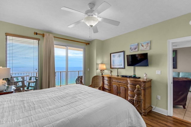 bedroom with access to outside, hardwood / wood-style floors, and ceiling fan