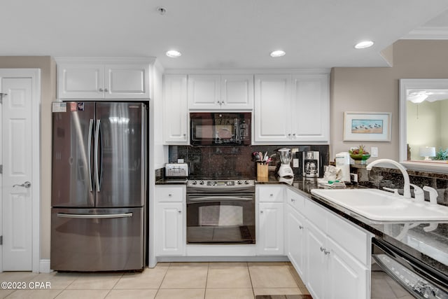 kitchen featuring black appliances, light tile patterned floors, sink, decorative backsplash, and white cabinets