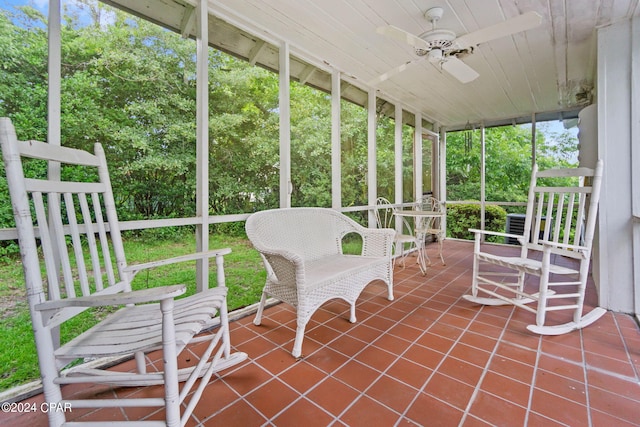 unfurnished sunroom featuring a ceiling fan