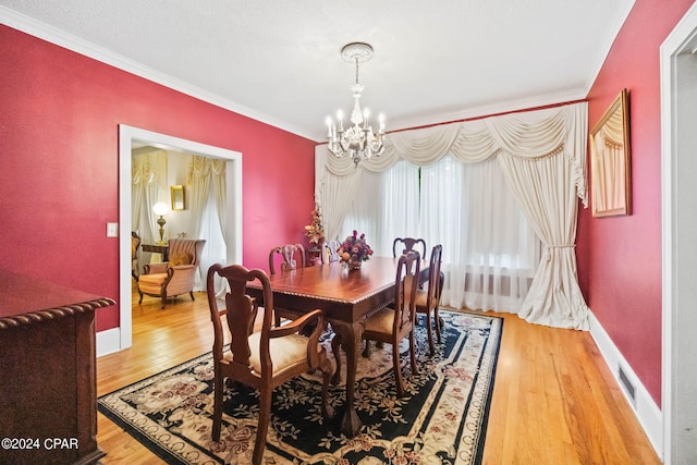 703 N Waukesha St, Bonifay, FL 32425 - dining room with a chandelier, ornamental molding, and light wood finished floors
