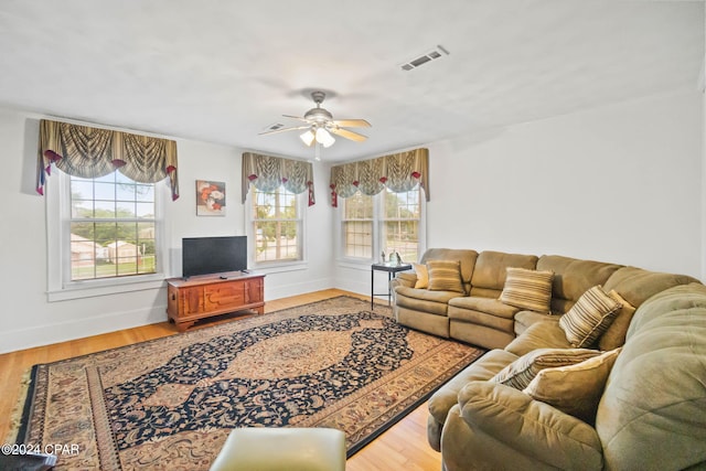 703 N Waukesha St, Bonifay, FL 32425 - living area with healthy amount of natural light, a ceiling fan, light wood-style flooring, and baseboards