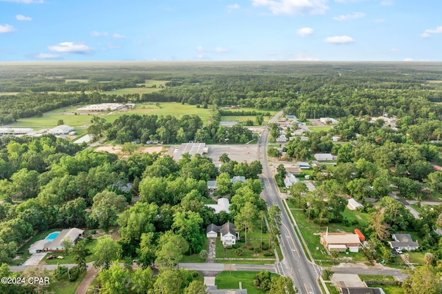 drone / aerial view featuring a wooded view