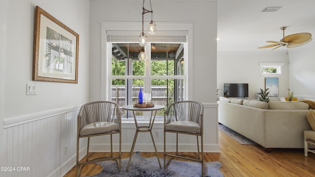 dining area with ceiling fan, a healthy amount of sunlight, and light wood-type flooring