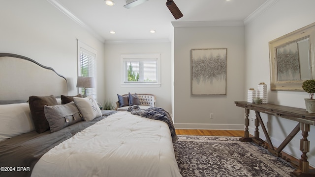 bedroom with ceiling fan, crown molding, and hardwood / wood-style floors