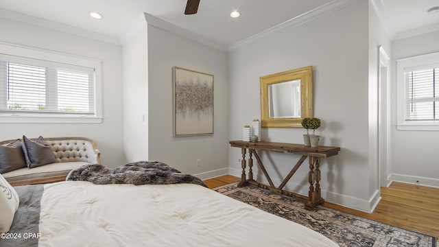 bedroom with ceiling fan, wood-type flooring, and crown molding