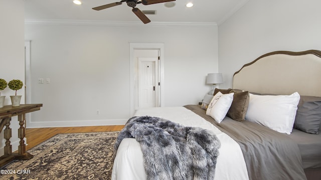 bedroom featuring ceiling fan, wood-type flooring, and ornamental molding