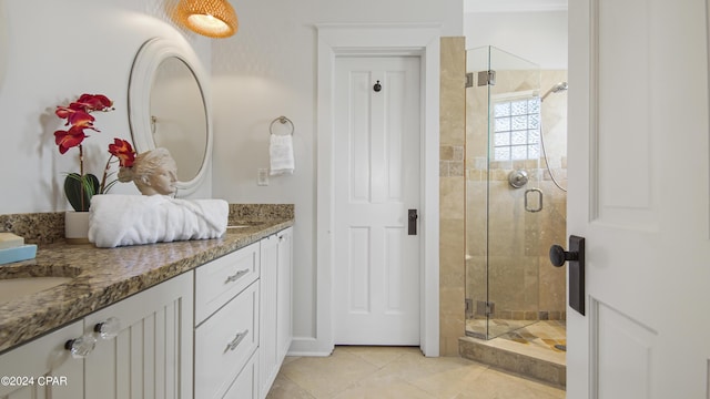 bathroom featuring an enclosed shower, vanity, and tile patterned flooring