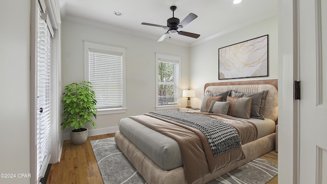 bedroom with ceiling fan, hardwood / wood-style flooring, and crown molding