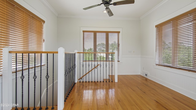 empty room featuring ceiling fan, crown molding, and light hardwood / wood-style flooring