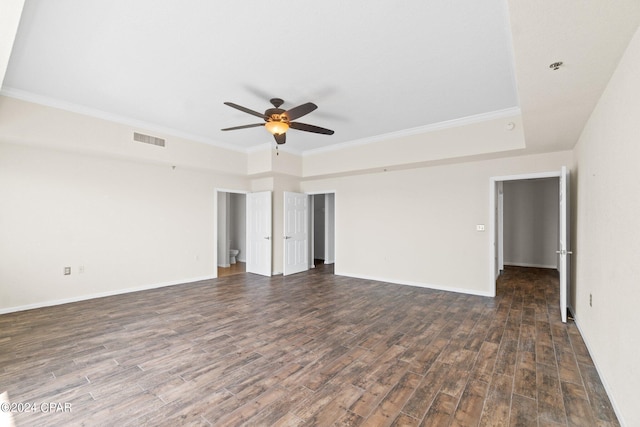 spare room with ceiling fan, wood finished floors, visible vents, baseboards, and ornamental molding