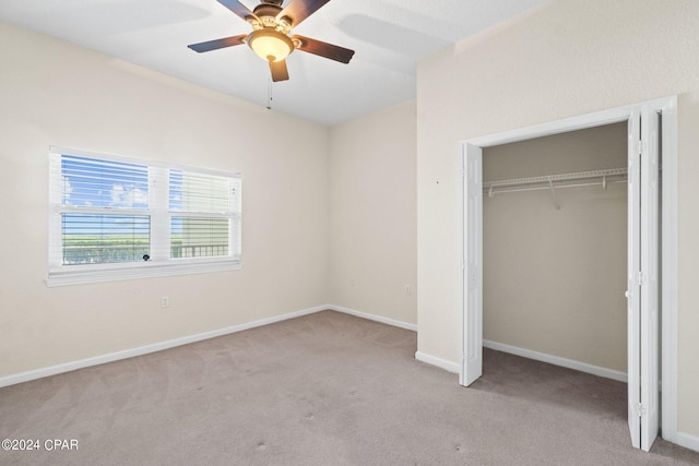 unfurnished bedroom featuring ceiling fan, light carpet, and a closet