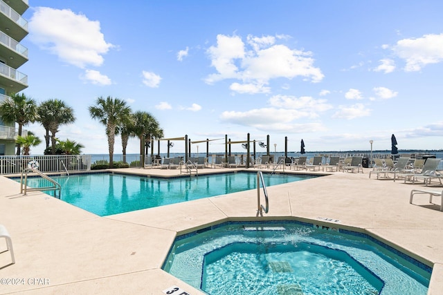 view of pool featuring a community hot tub and a patio