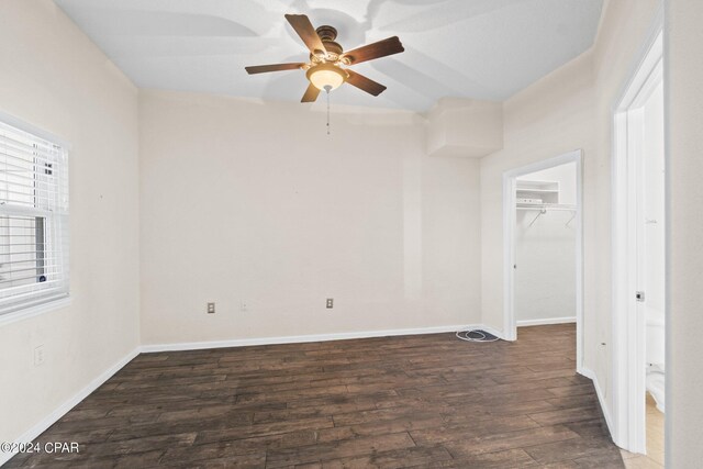 empty room with ceiling fan and dark hardwood / wood-style floors