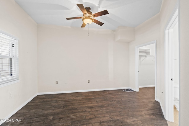 spare room featuring a ceiling fan, baseboards, and wood finished floors