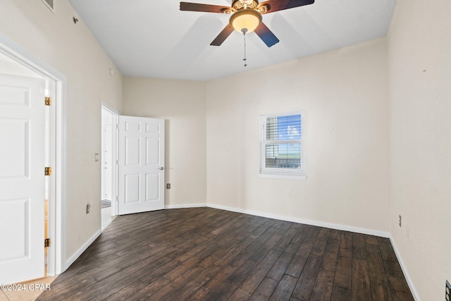 spare room featuring dark hardwood / wood-style floors and ceiling fan