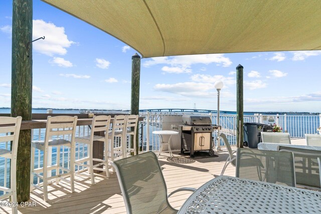 wooden deck featuring a grill and a water view