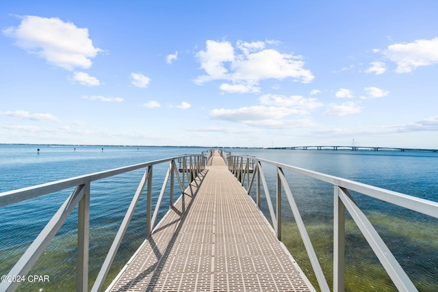 dock area featuring a pier and a water view