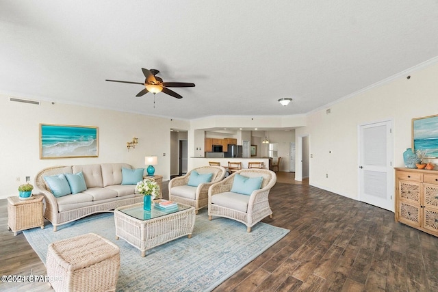 living area featuring a ceiling fan, crown molding, visible vents, and wood finished floors