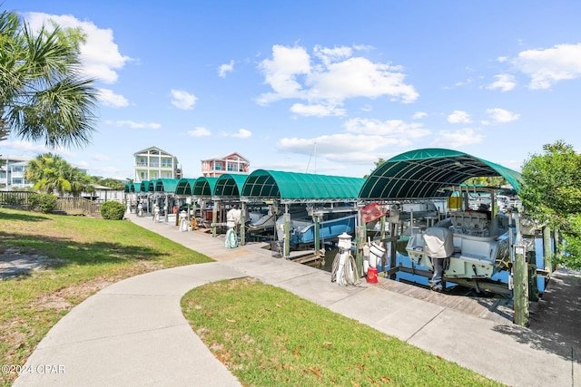 view of property's community featuring a yard, a dock, and boat lift