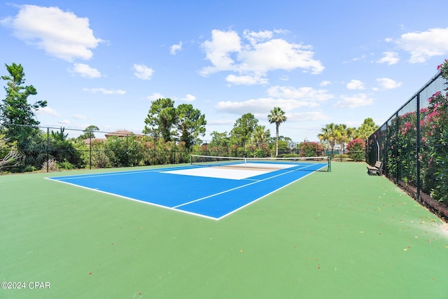 view of tennis court with basketball hoop