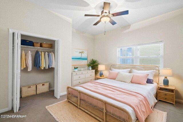 carpeted bedroom featuring a closet and ceiling fan