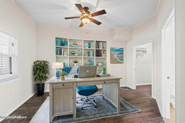 home office with a ceiling fan, baseboards, and dark wood-type flooring