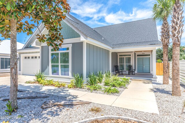 view of front of house with a porch and a garage