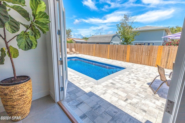 view of swimming pool with a patio area