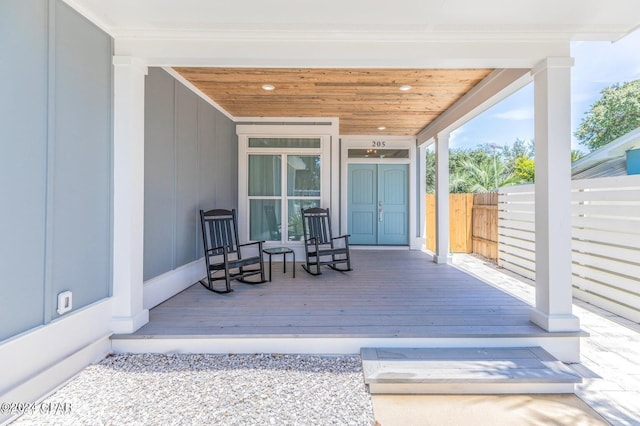 wooden terrace featuring covered porch