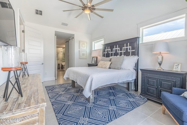 bedroom featuring ceiling fan, lofted ceiling, and ensuite bath