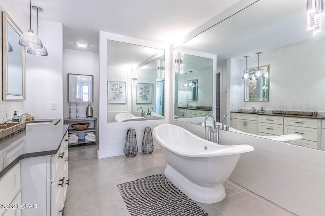 bathroom featuring tile patterned floors, vanity, and a bathtub