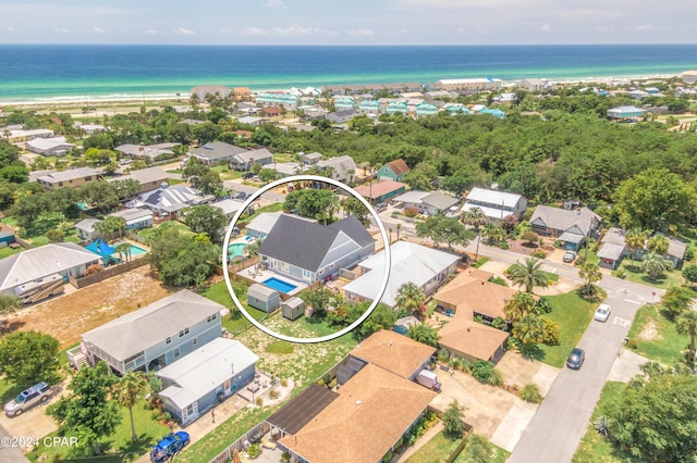 bird's eye view with a water view and a beach view