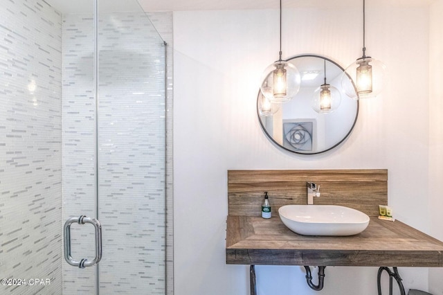 bathroom with sink and an enclosed shower