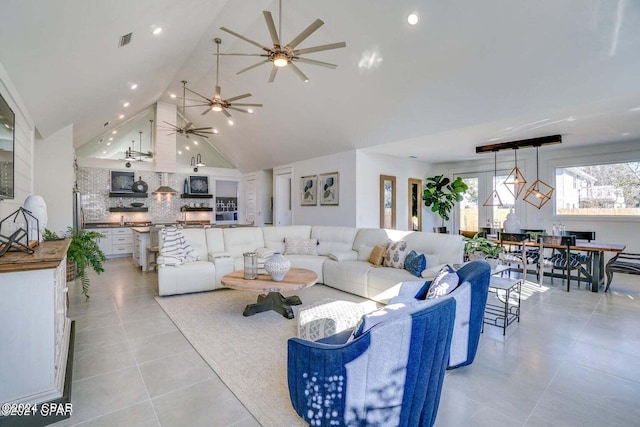 living room with light tile patterned floors and high vaulted ceiling