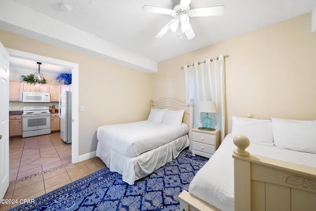 bedroom with ceiling fan, light tile patterned flooring, and white refrigerator