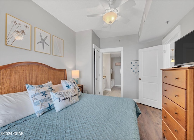 bedroom with connected bathroom, ceiling fan, baseboards, and wood finished floors