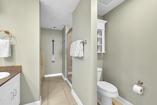 bathroom featuring toilet, visible vents, vanity, tile patterned floors, and a stall shower