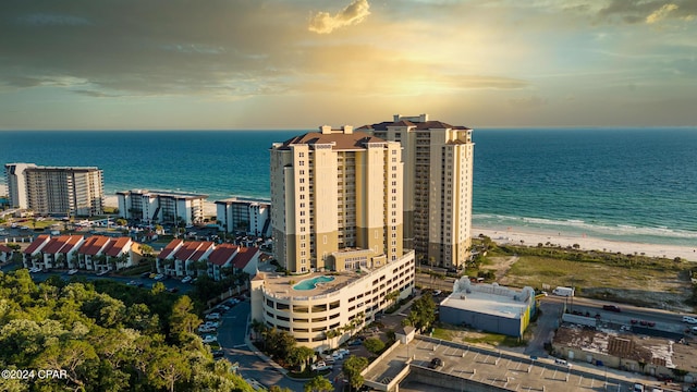 aerial view at dusk with a view of city, a beach view, and a water view