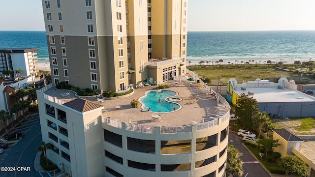 birds eye view of property featuring a water view and a beach view