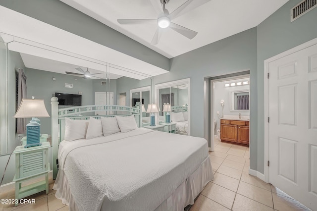 tiled bedroom with ensuite bathroom and ceiling fan