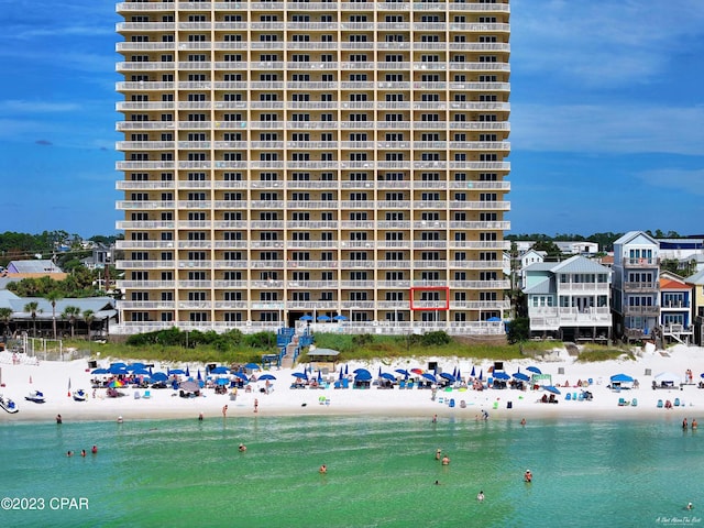 view of property with a beach view and a water view