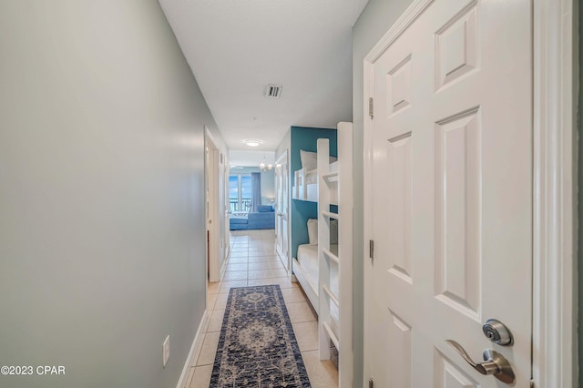 hall featuring light tile patterned flooring