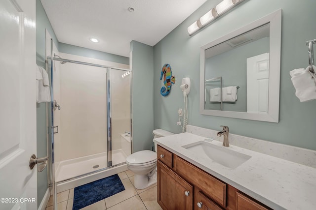 bathroom with tile patterned flooring, a shower with door, and toilet