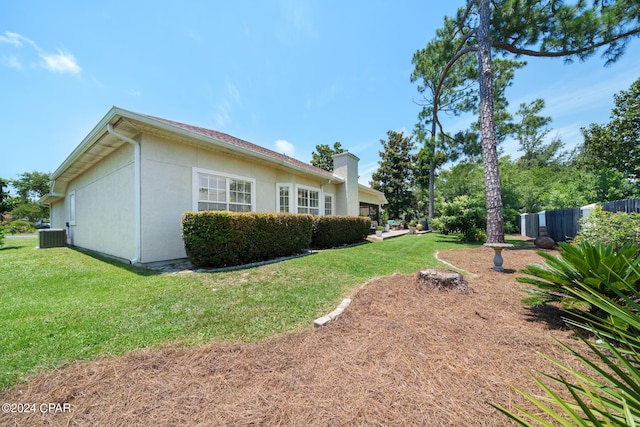 view of property exterior featuring a lawn